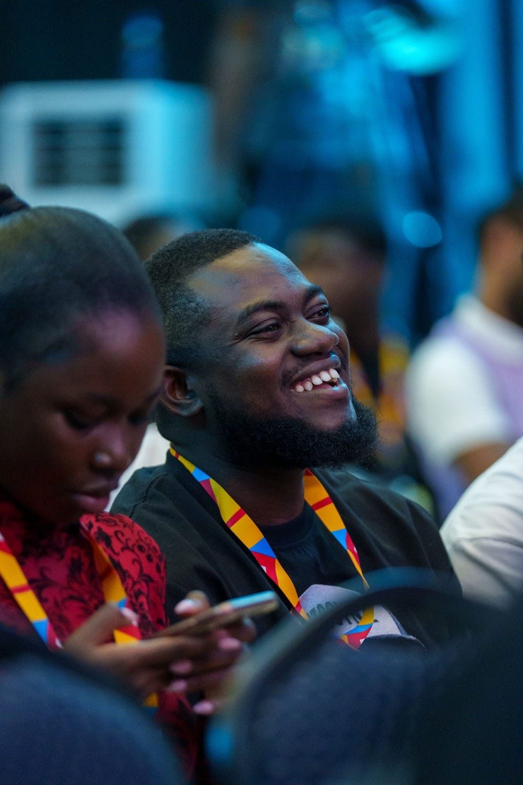 dEX Design Conference 2025 — an attendee laughing in the audience