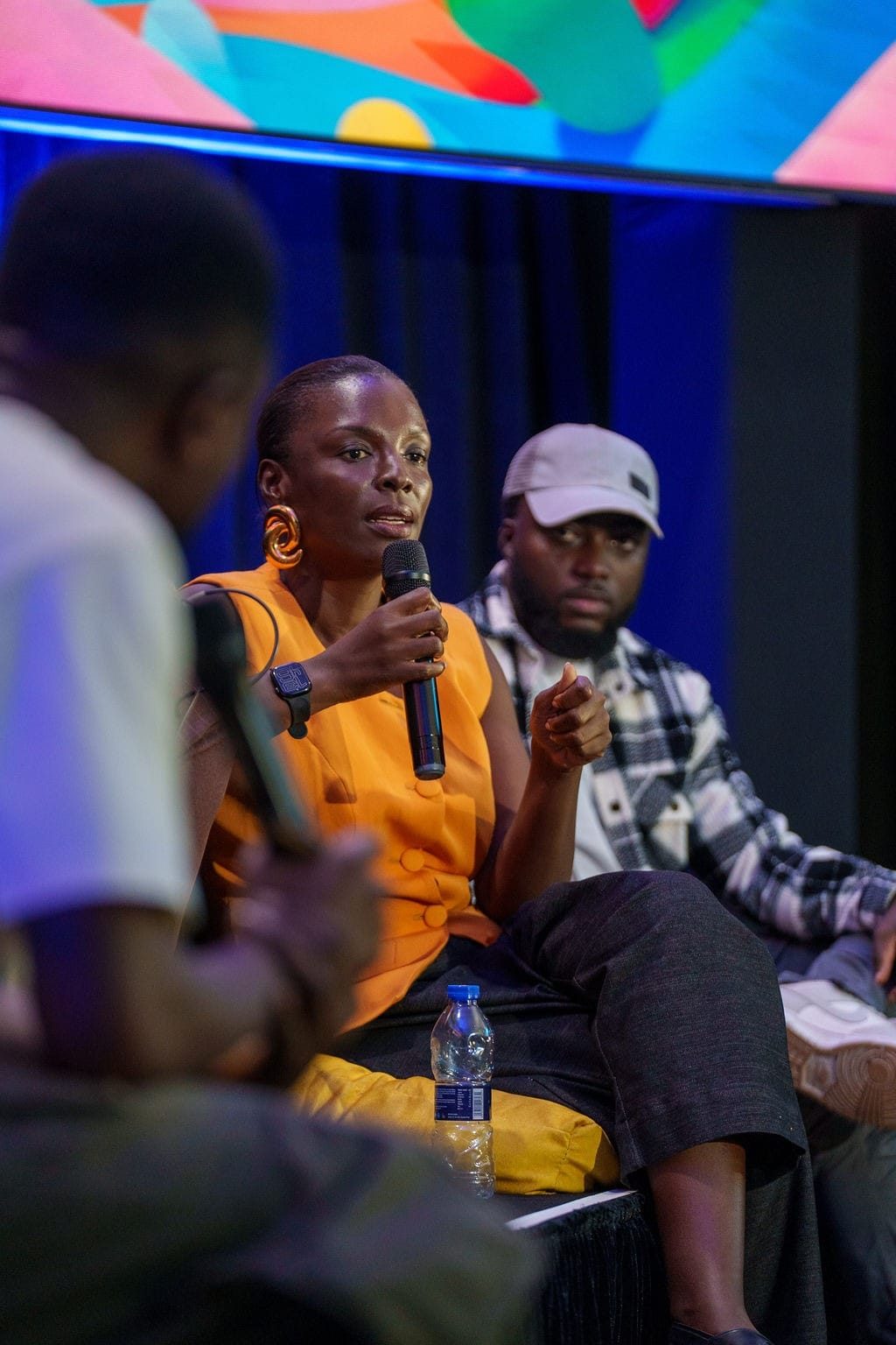 dEX Design Conference 2025 — a speaker holding a microphone during a panel