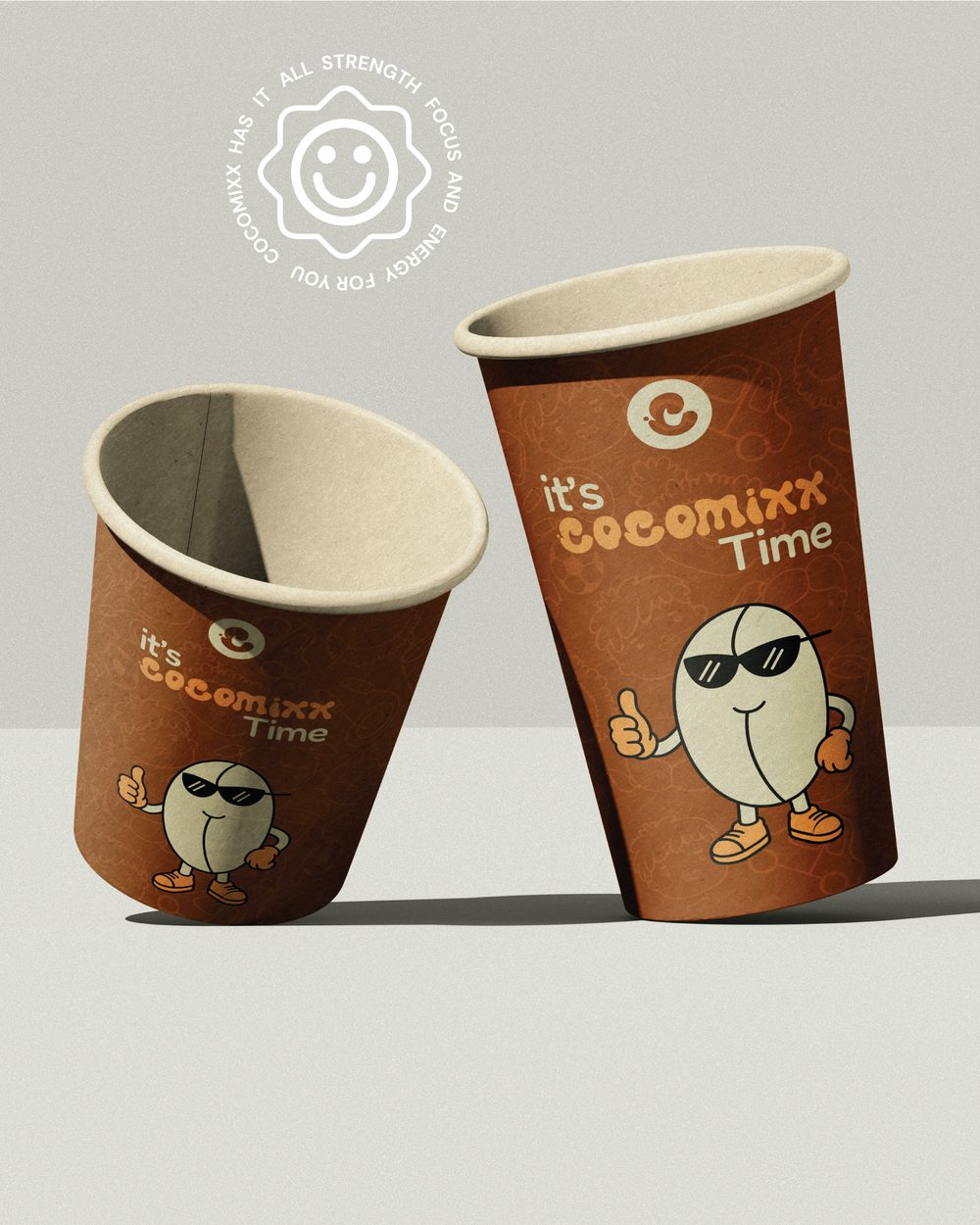 Cocomixx branded paper cups reading "it's Cocomixx Time" with the cocoa bean mascot